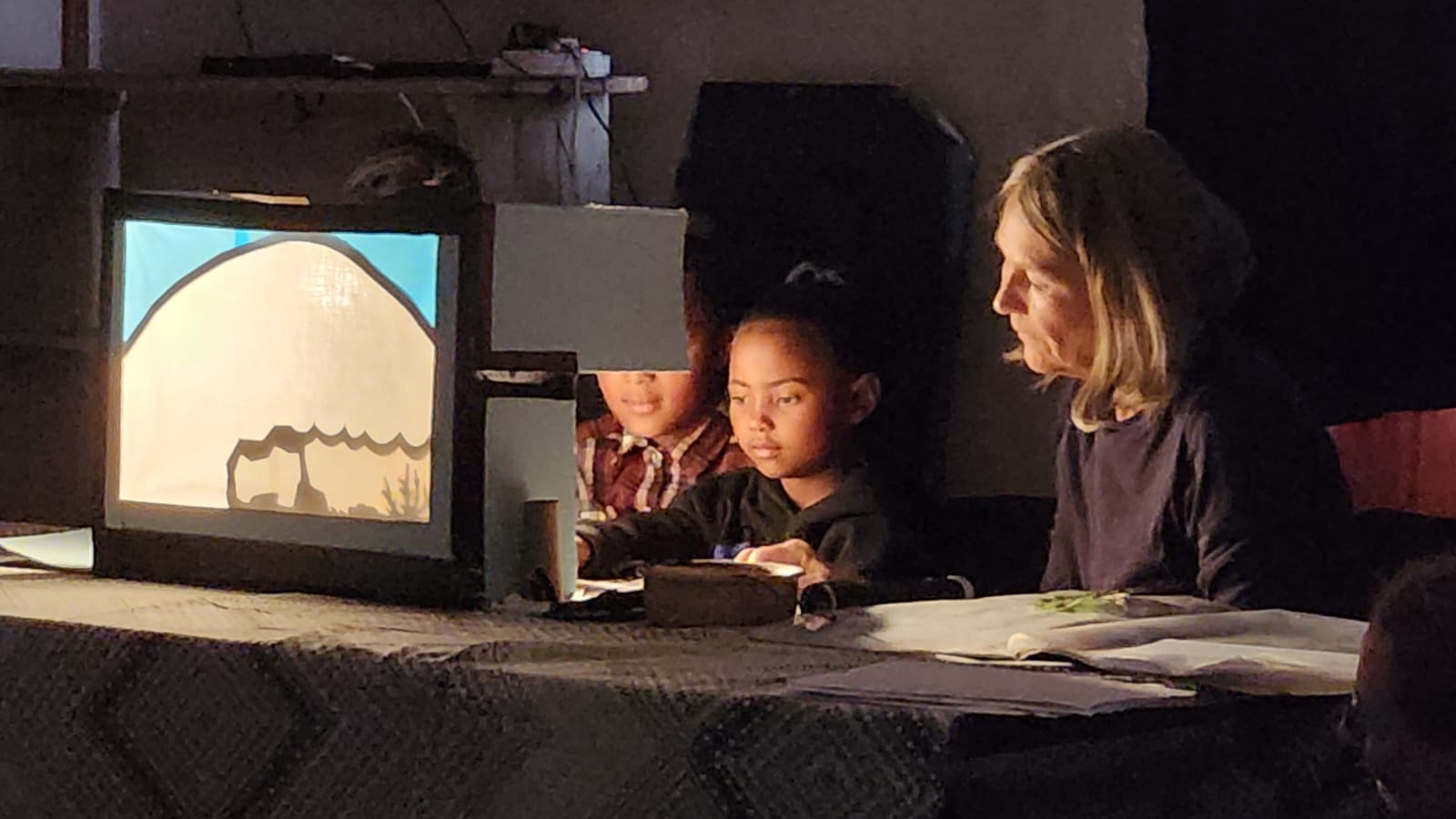 Children performing the Shadow Theatre Creation Story